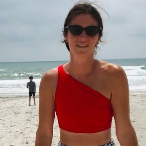 Kiava asymmetrical red swim top- tiiiiny pick in fabric finger next to it in pic